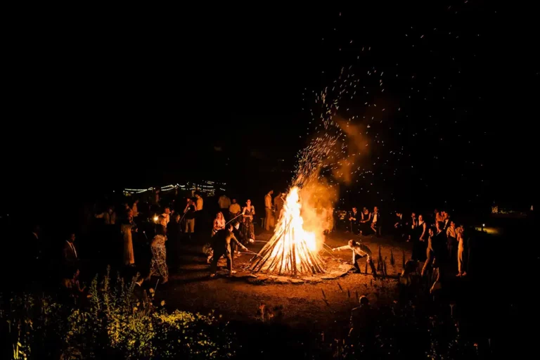 Chill vibes at the extra large bonfire at the end of a wedding at Roxbury Barn & Estate