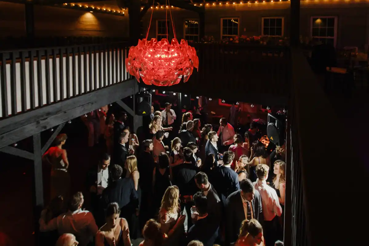 Dance party at a Catskills wedding reception at the two-level carriage barn at Roxbury Barn & Estate, premier wedding venue in upstate New York
