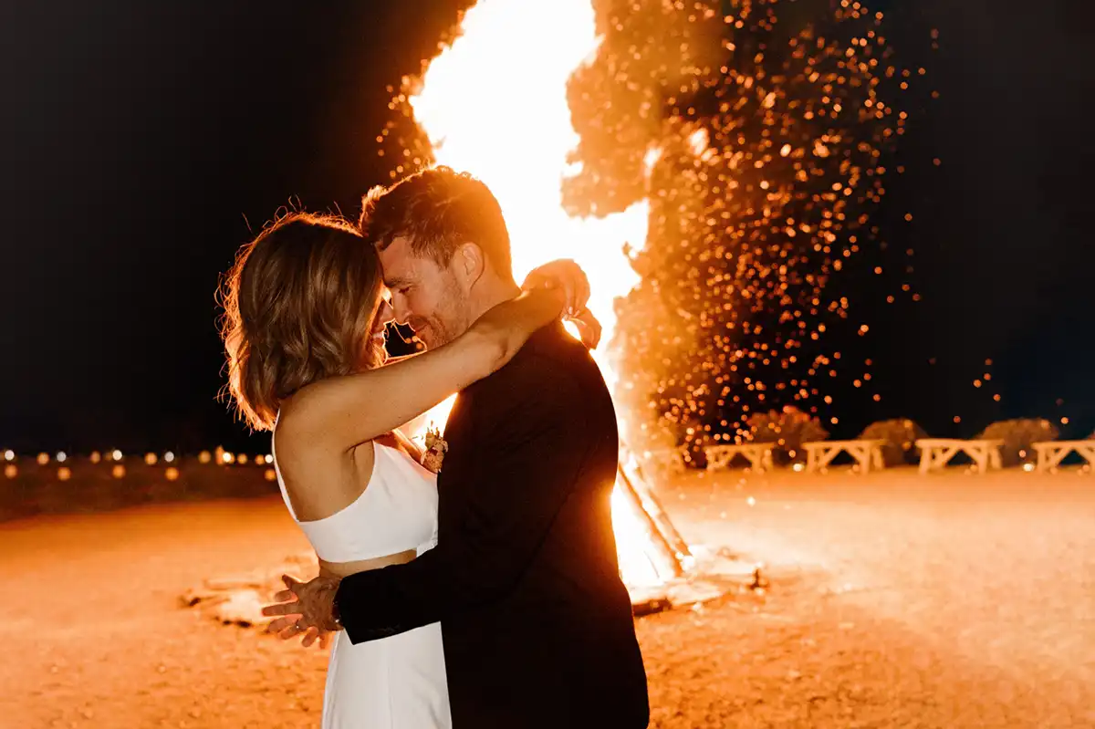 Bride and groom at the large bonfire at the end of their Catskills wedding celebration at Roxbury Barn & Estate